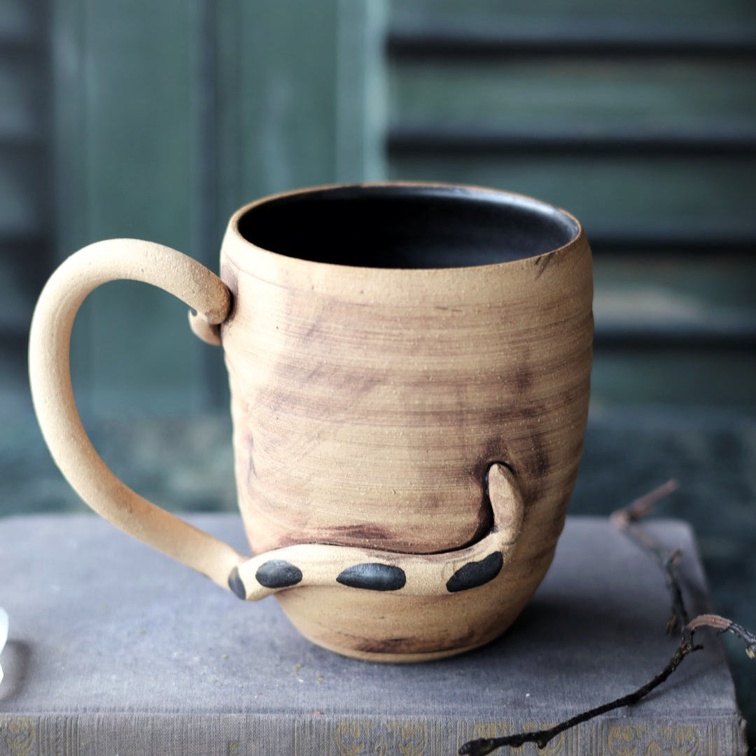 Ceramic mug with a unique design on a book